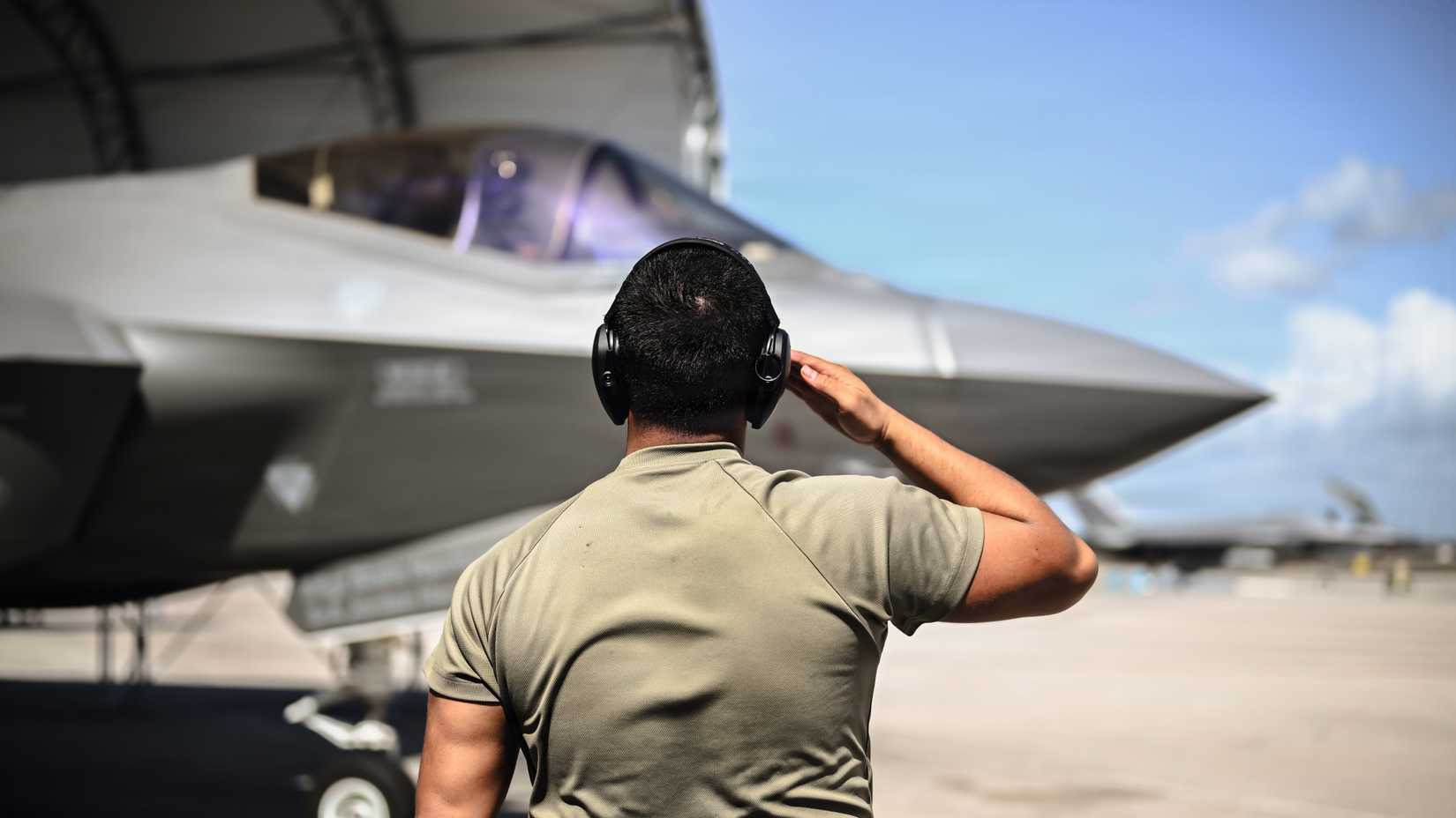 Air Force Airman 1st Class Isaiah Mendiha, 95th Fighter Generation Squadron assistant dedicated crew chief, salutes an F-35A Lightning II pilot.-1