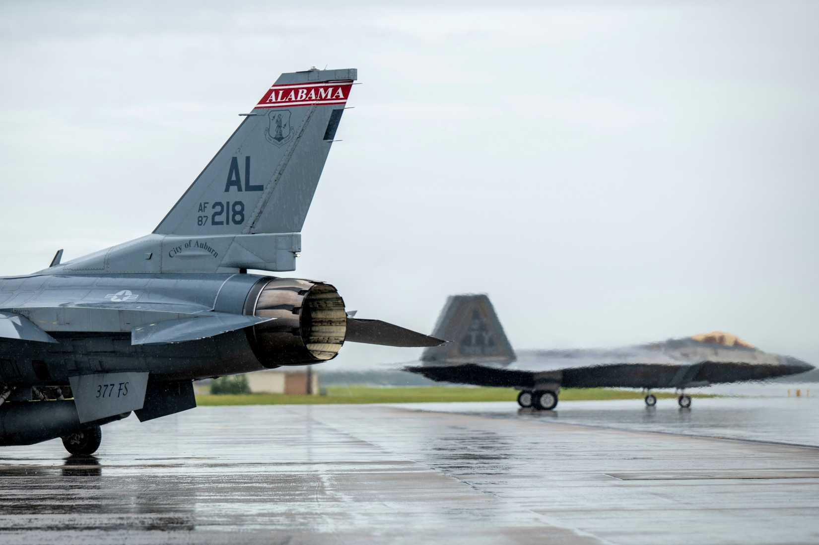 Air Force F-16 Fighting Falcon and F-22 Raptor sit on the parking ramp at Eglin Air Force Base, Florida, Aug. 12, 2022.
