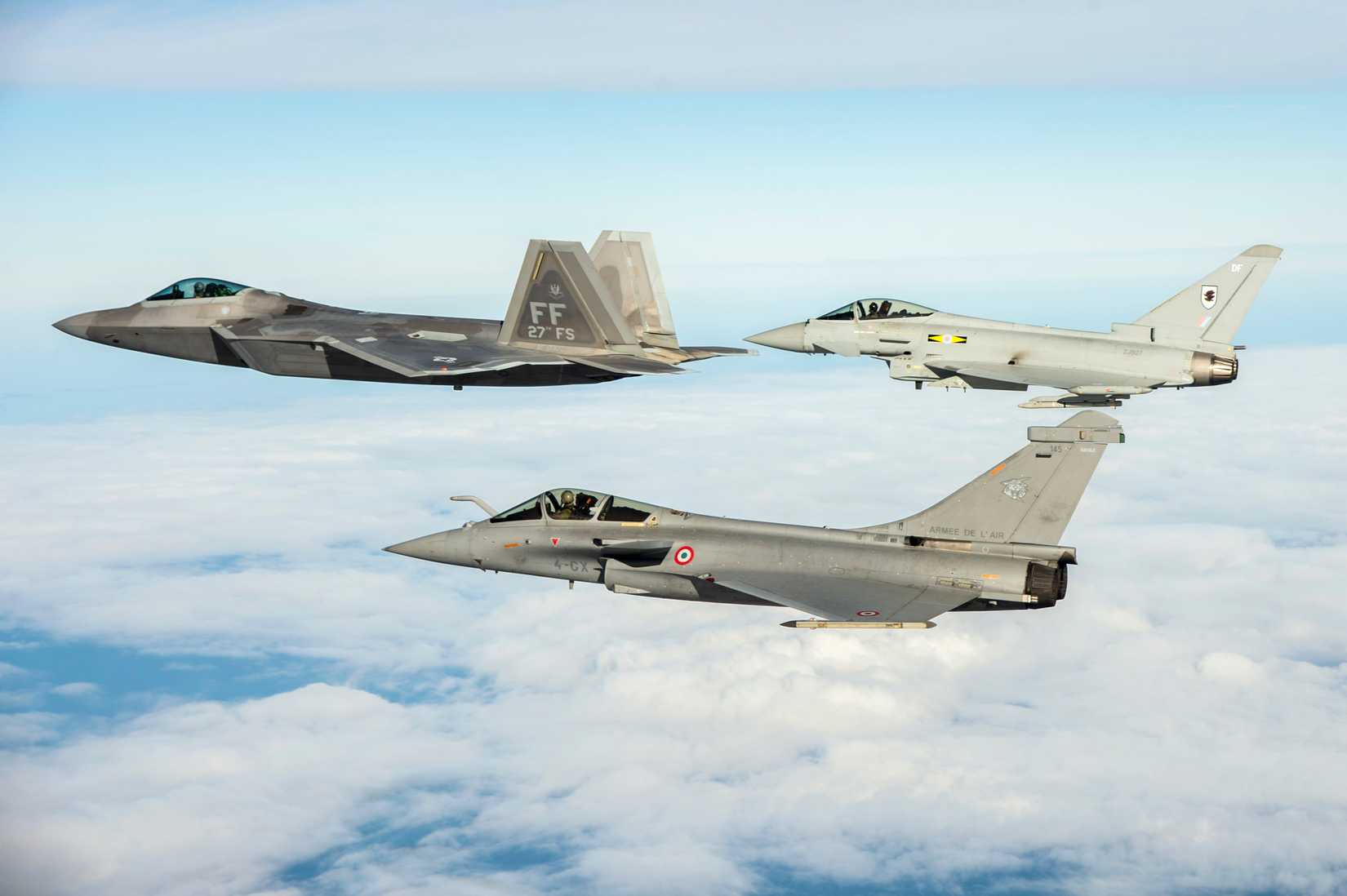 Air Force F-22 Raptor, British Royal Air Force Typhoon, and French air force Rafale fly in formation as part of a Trilateral Exercise held at Langley Air Force Base, Va., Dec. 7, 2015.