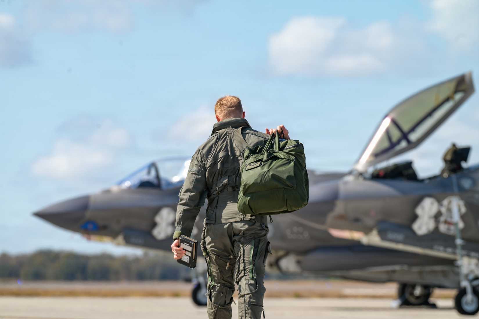 Air Force Lt. Col. Hunter Grunden, 60th Fighter Squadron commander, steps to an F-35A Lightning II.