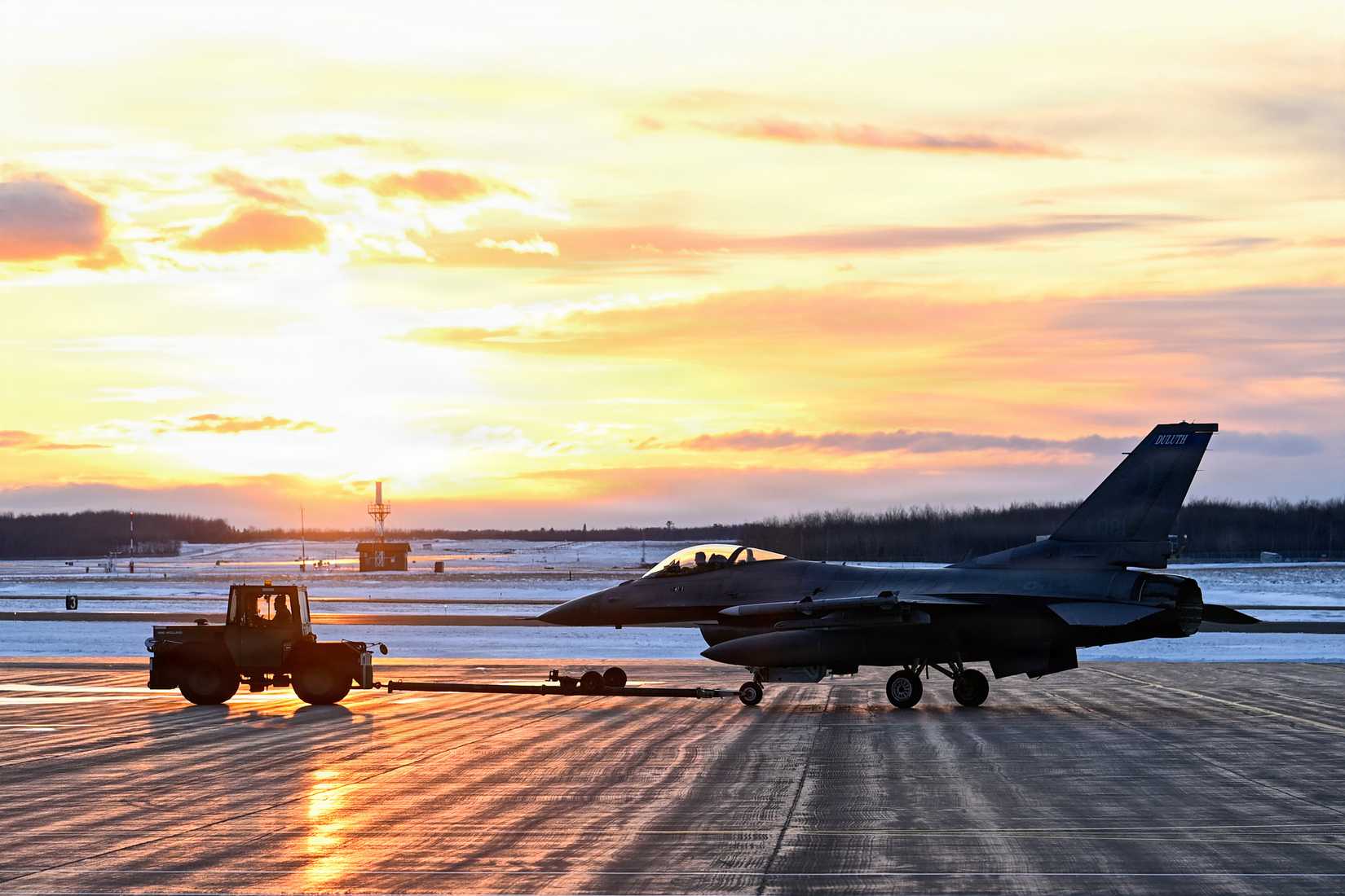 Air Force Master Sgt. Philip Broome, tactical aircraft maintenance, tows an F-16 Fighting Falcon.