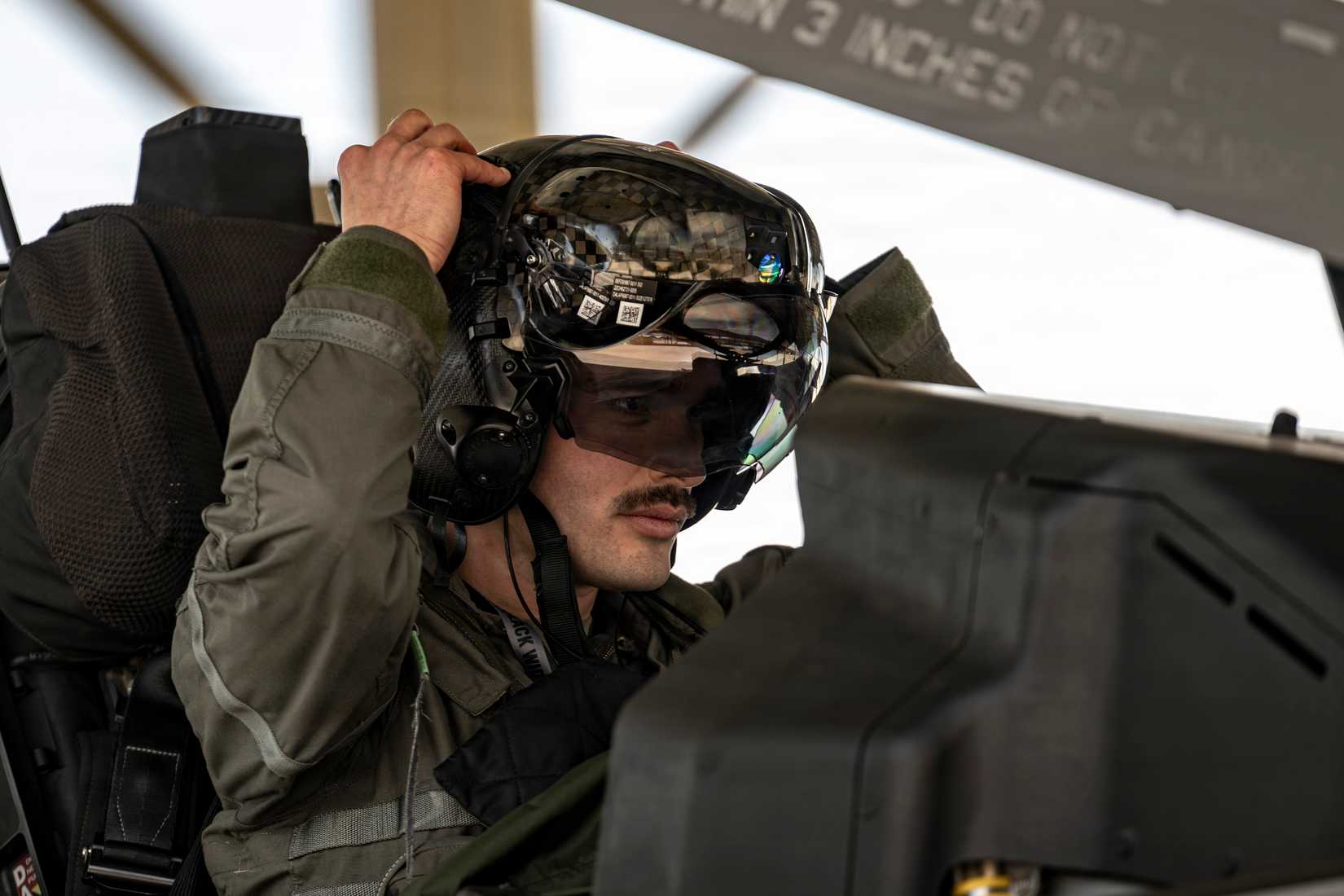Air Force pilot assigned to the 421st Fighter Squadron secures his helmet at Hill Air Force Base-1