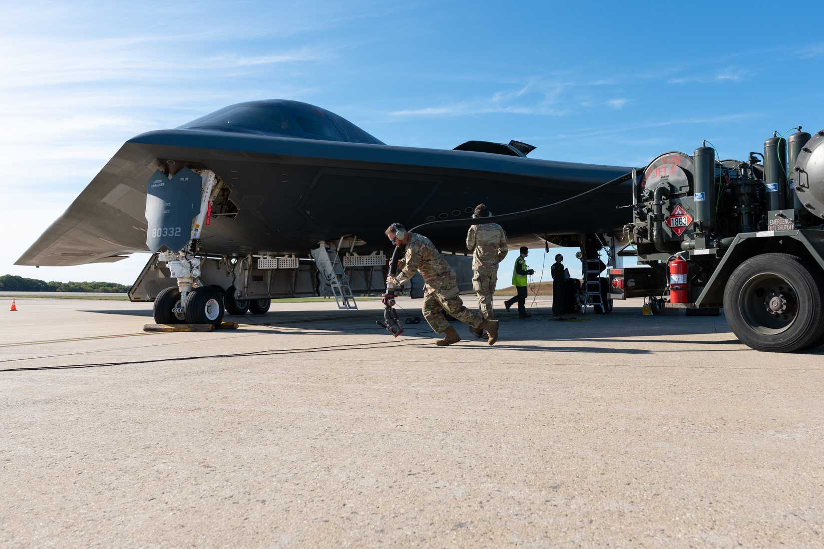 Airmen assigned to the 509th Bomb Wing conduct hot-pit refueling operations for a B-2 Spirit aircraft at Pease Air National Guard Base, New Hampshire, Sept. 20, 2025.