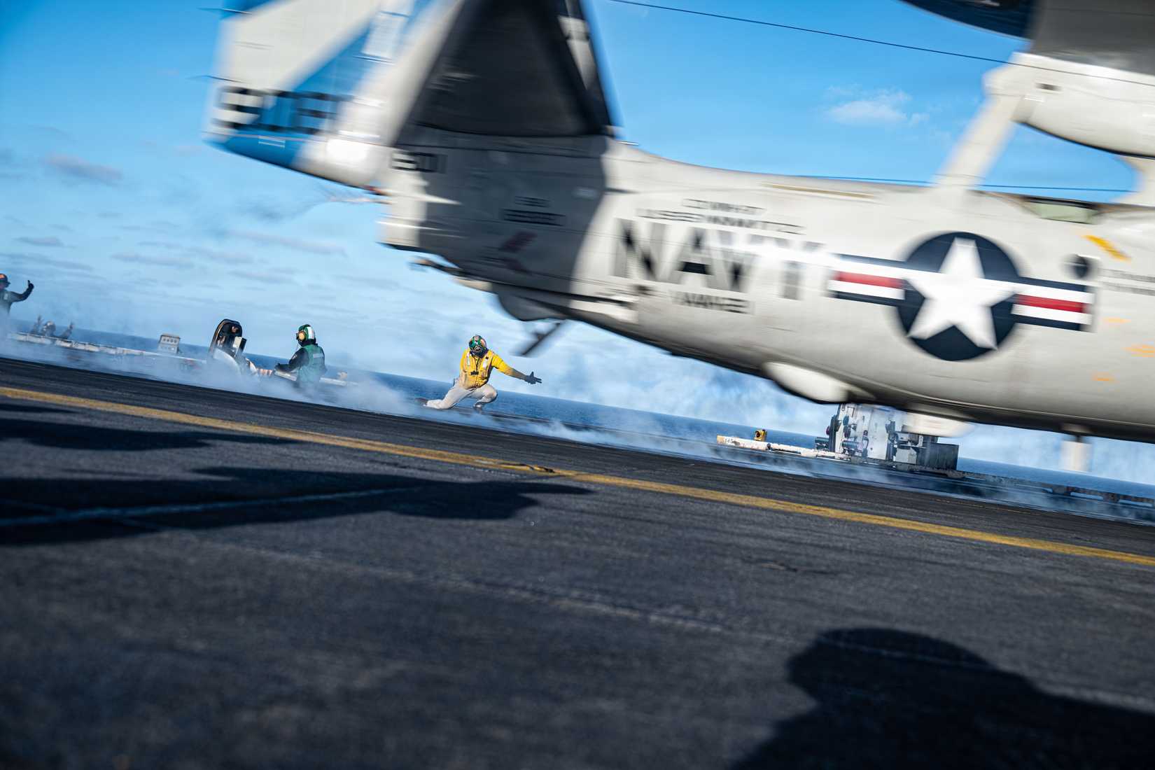 An E-2D Hawkeye, attached to the “Bluetails” of Carrier Airborne Early Warning Squadron (VAW) 121, launches from the flight deck.