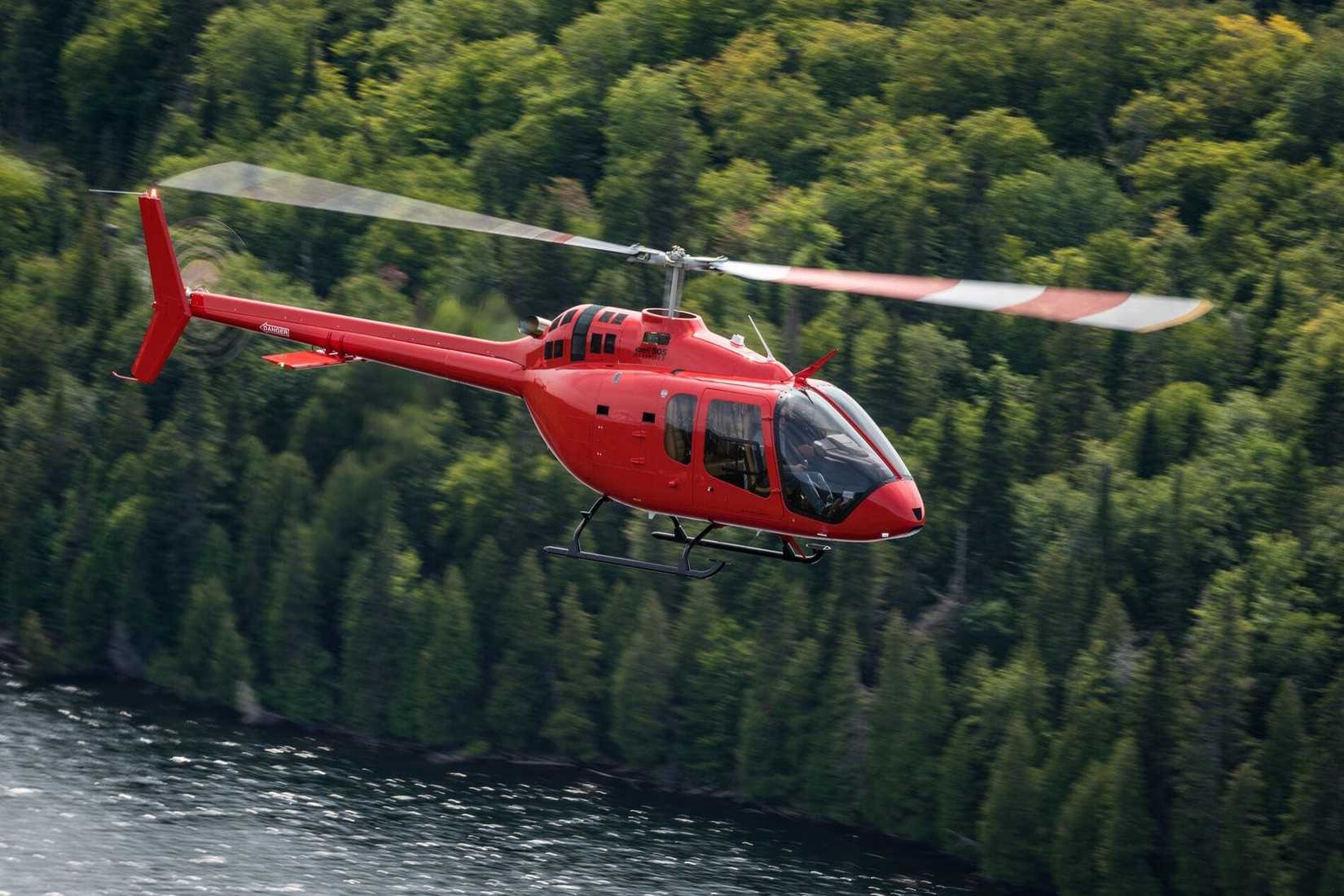 Bell 505 helicopter in flight.