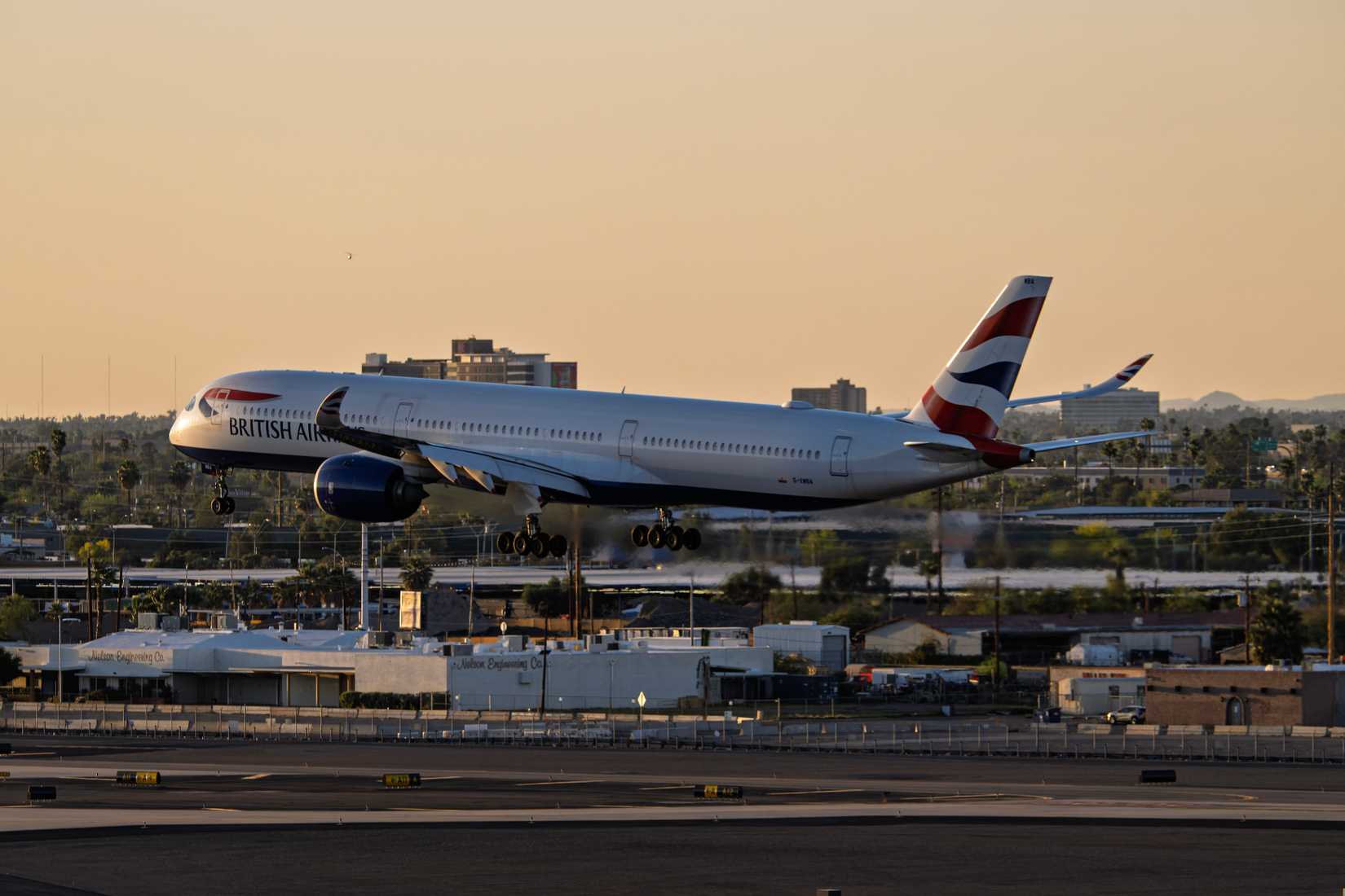 British Airways Airbus A350-1000 G-XWBA sunset arrival at Phoenix Sky Harbor Intl. Airport.