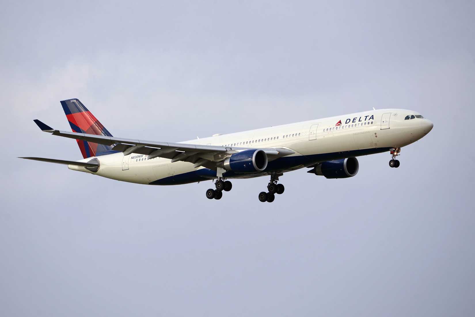 Delta Air Lines A330-300 flying across grey skies