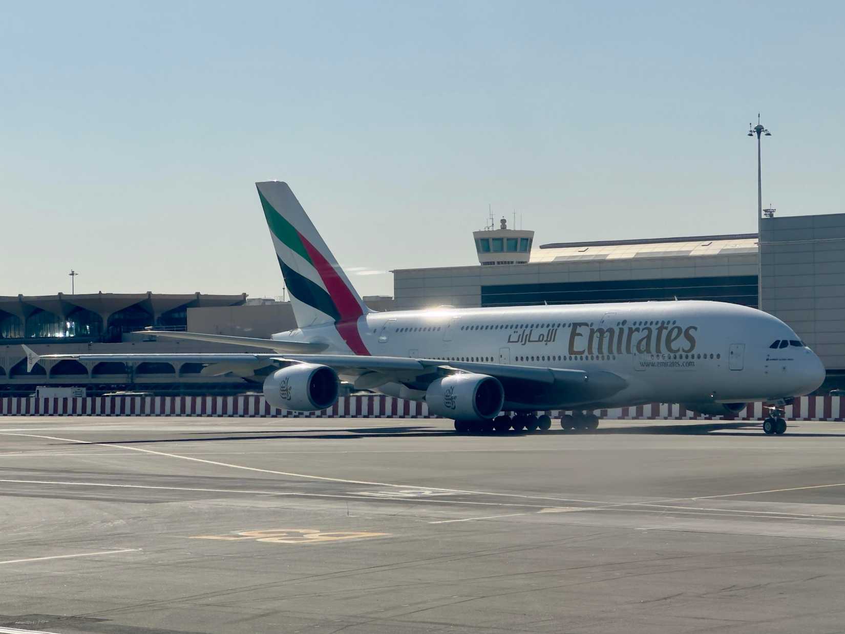 Emirates Airbus A380 parked outside the terminal of Dubai International Airpot.