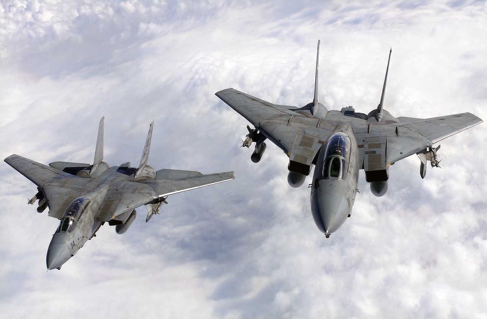 Two F-14s flying above the clouds