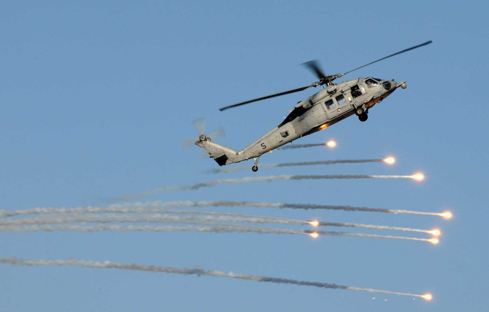An MH-60S Sea Hawk helicopter assigned to the Golden Falcons of Helicopter Sea Combat Squadron (HSC) 12 launches flares during practice