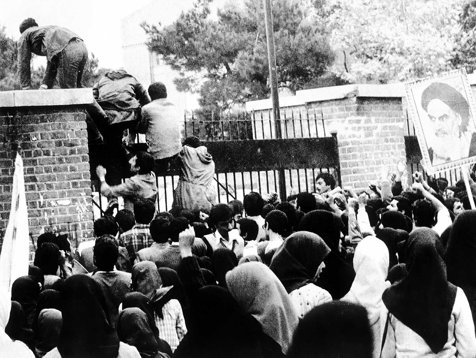 Black and white image of Iranian students storming the US embassy in Tehran