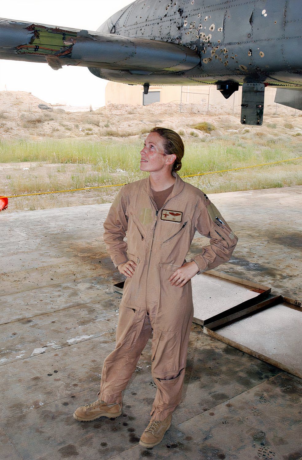 Captain Kim Campbell next to her damaged A-10