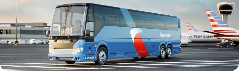Landline bus on tarmac by American Airlines planes.