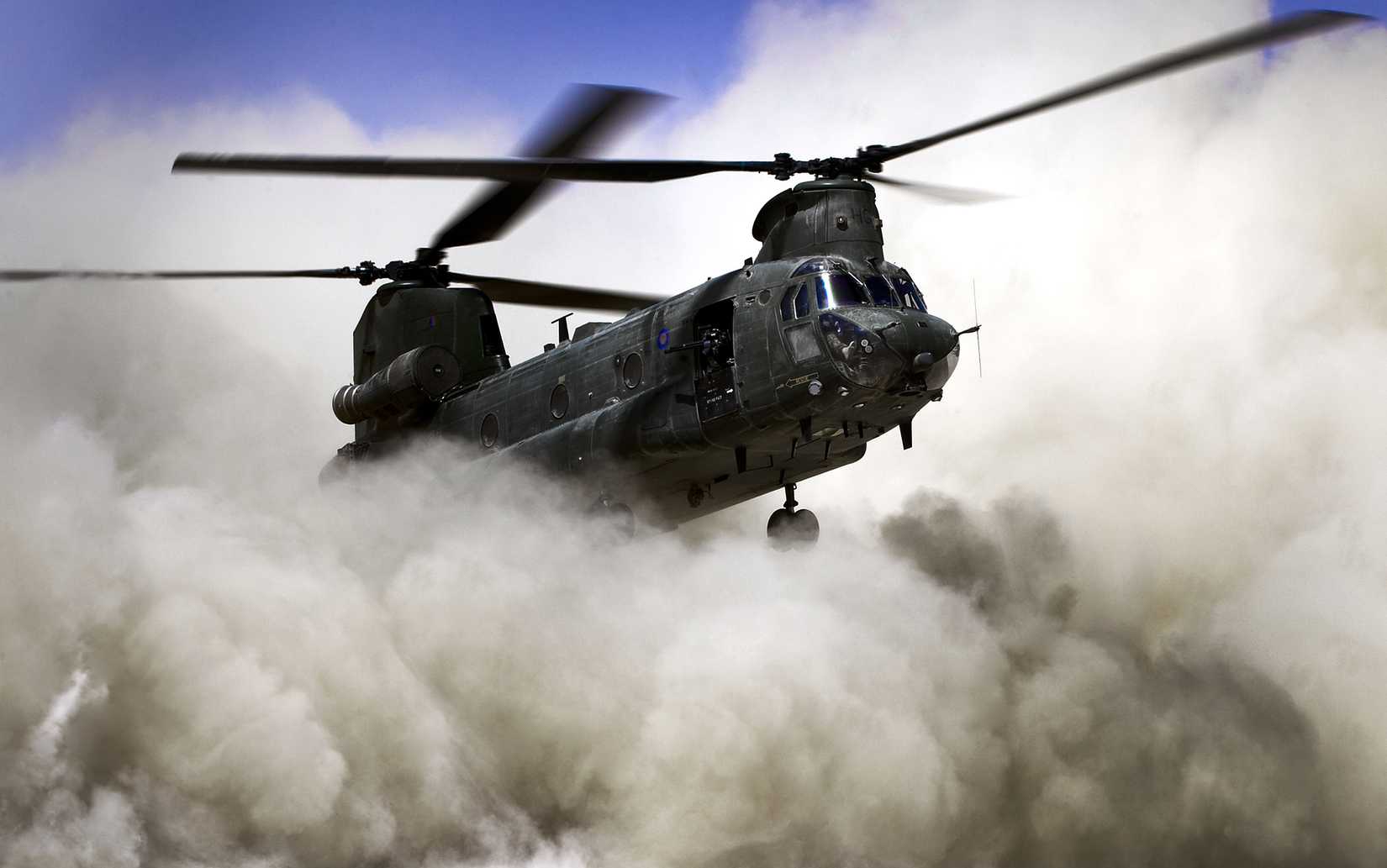 RAF Chinook helicopter creating a dust cloud during a landing