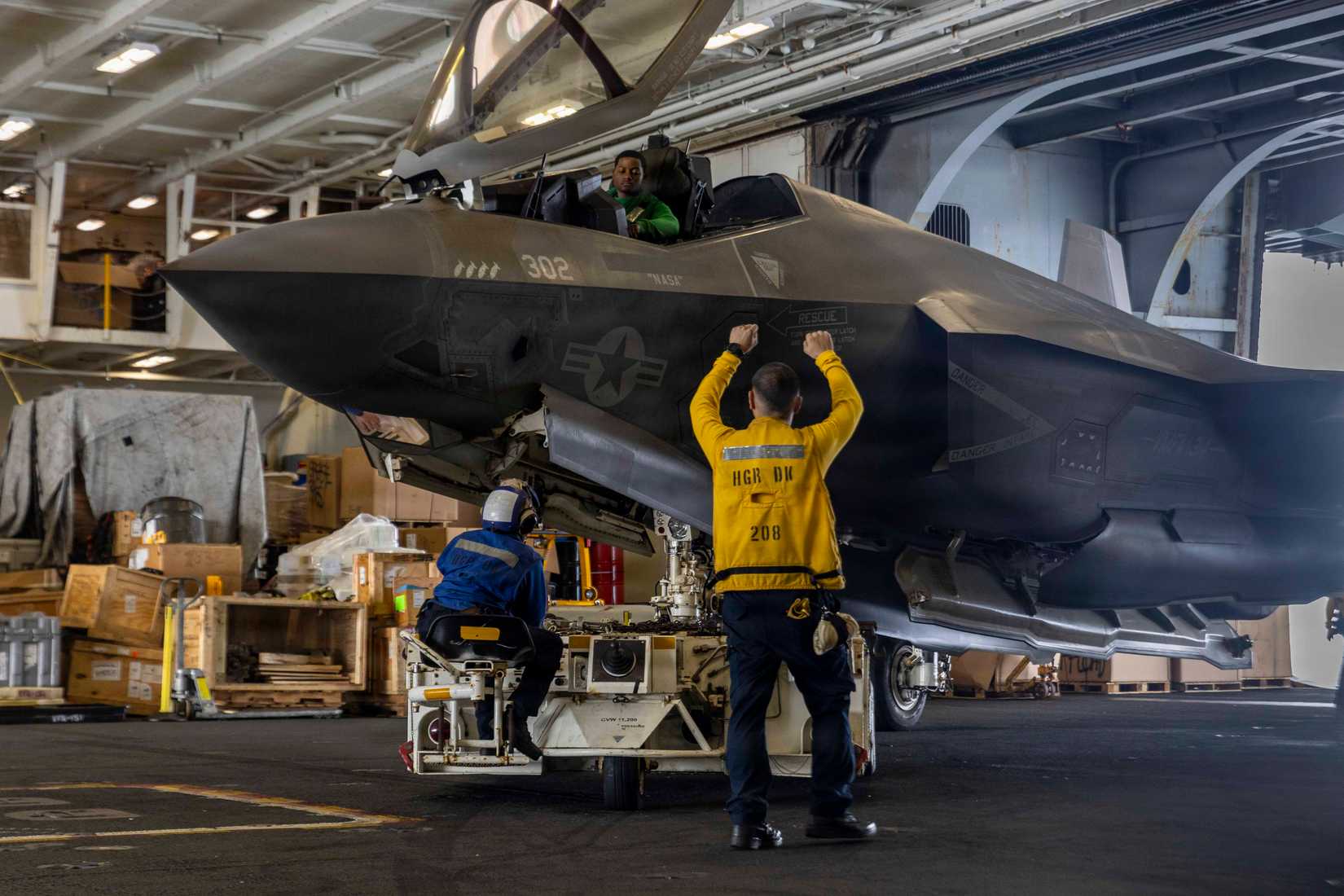 Sailors taxi an F-35C Lightning II, attached to Marine Fighter Attack Squadron (VMFA) 314, in the hangar bay aboard USS Abraham Lincoln (CVN 72).