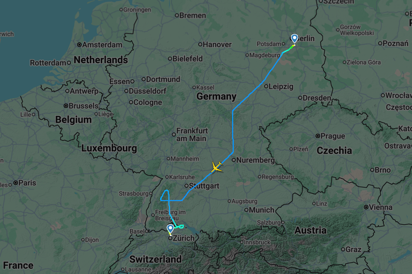 A flight tracking map shows the path of an aircraft traveling from Berlin to Zurich, crossing over central and southern Germany. The flight path heads southwest before performing a series of maneuvers near the Swiss-German border, with a yellow airplane icon currently positioned near Nuremberg.