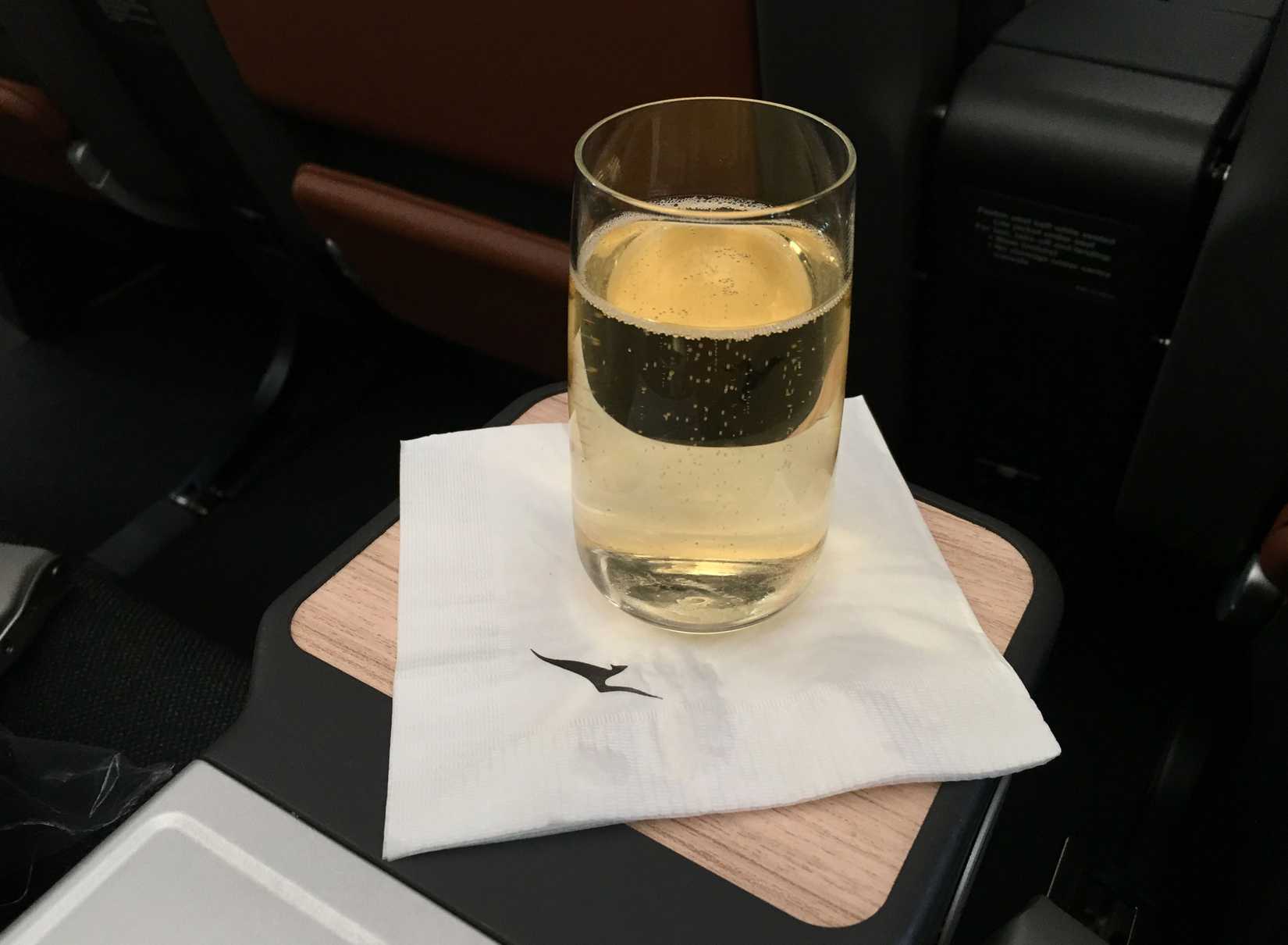 Qantas serves its premium economy passengers sparkling wine aboard flight QF95, served by its Boeing 787 Dreamliner aircraft.