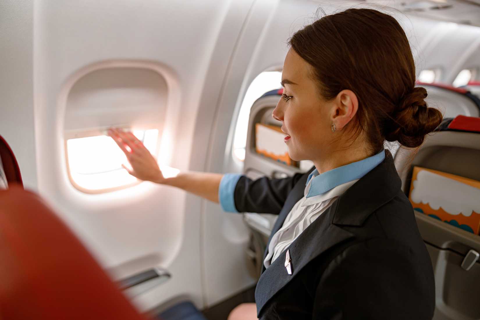 flight attendant closing window shade