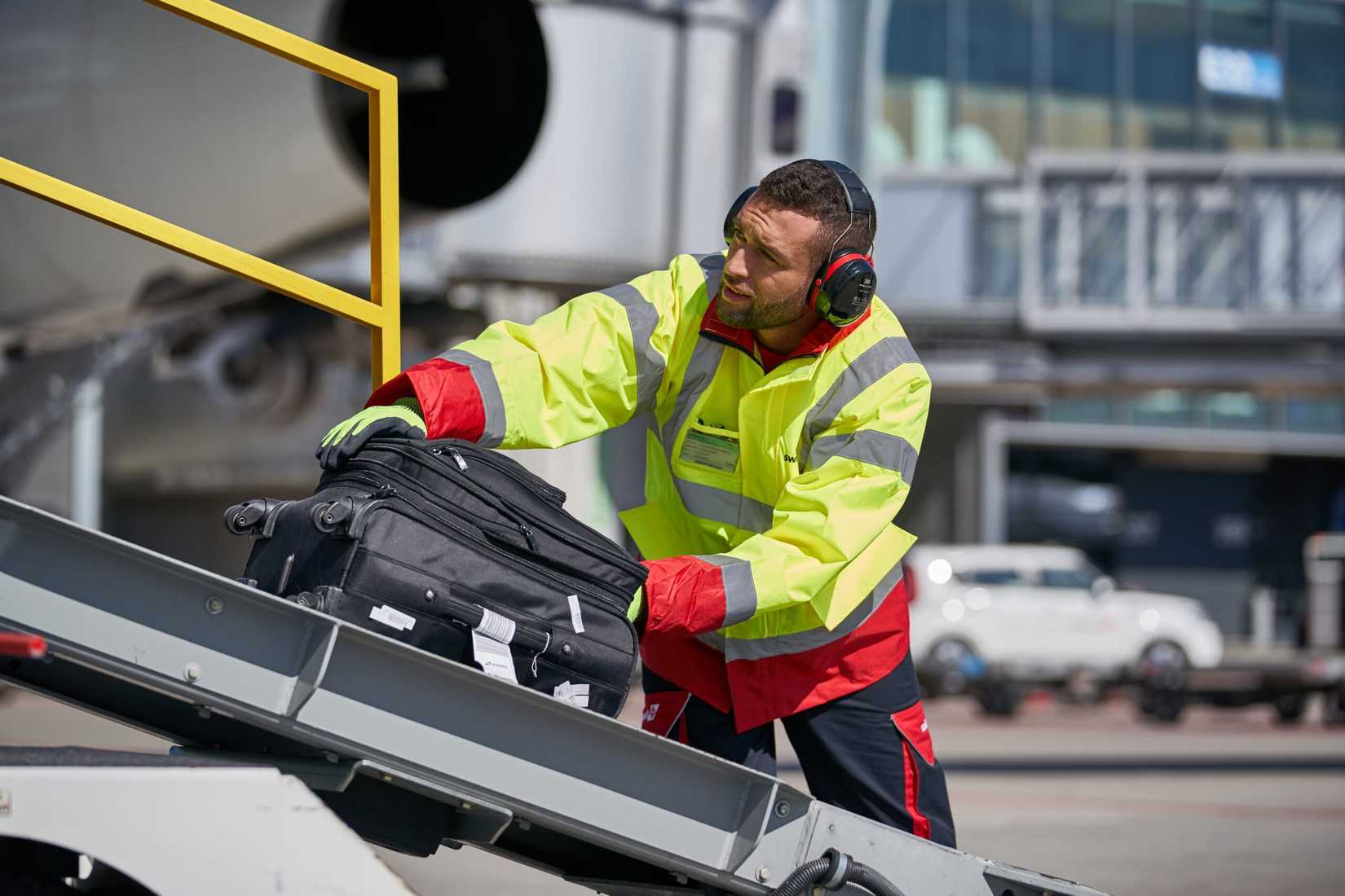 Baggage handler loading aircraft