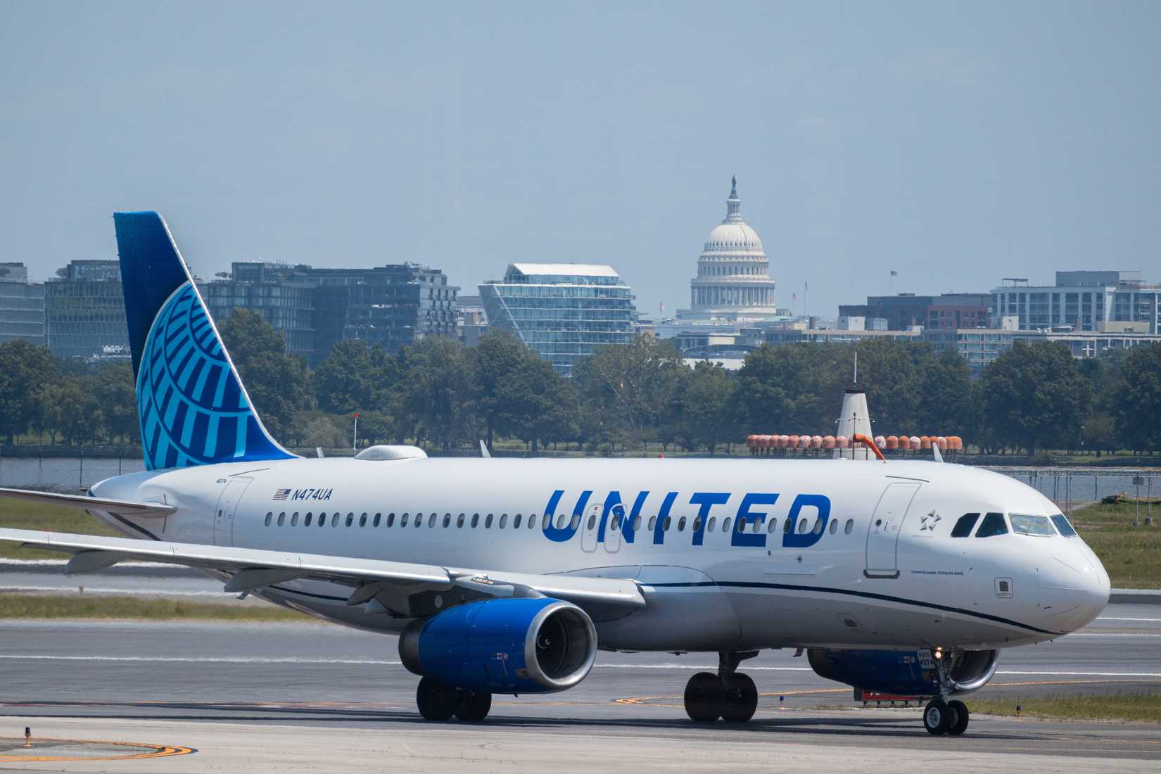 United Airlines Airbus taking off with US Capitol in background.