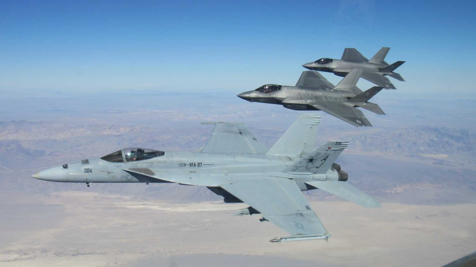 VFA-125 F-35C Lightning II from Naval Air Station (NAS) Lemoore,  flies in formation with FA-18E Super Hornets from VFA-97.