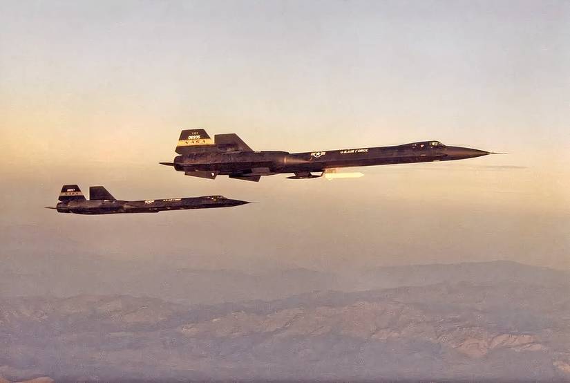 YF-12A and YF-12C in flight formation at dawn