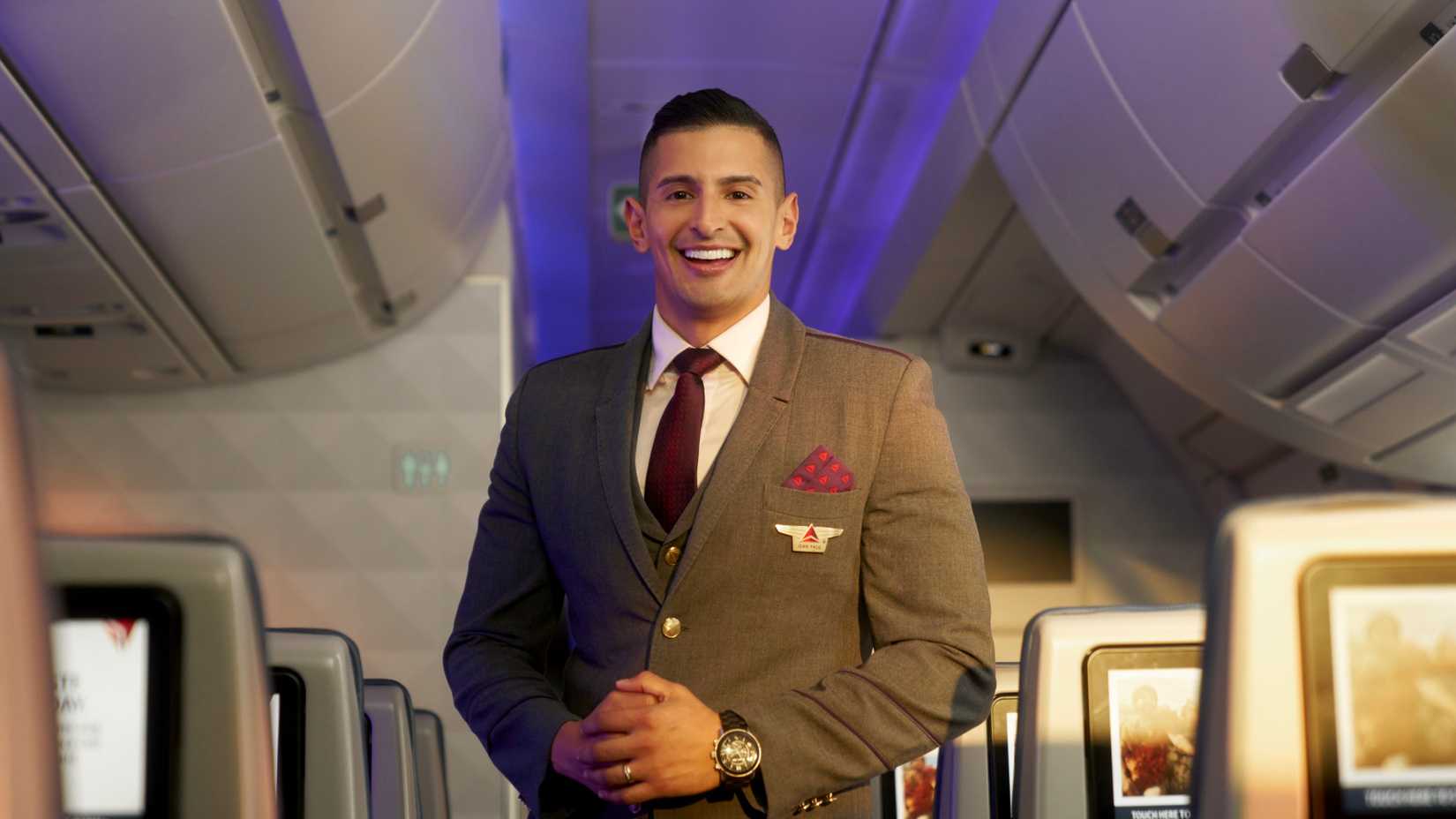 Delta Air Lines male flight attendant in cabin