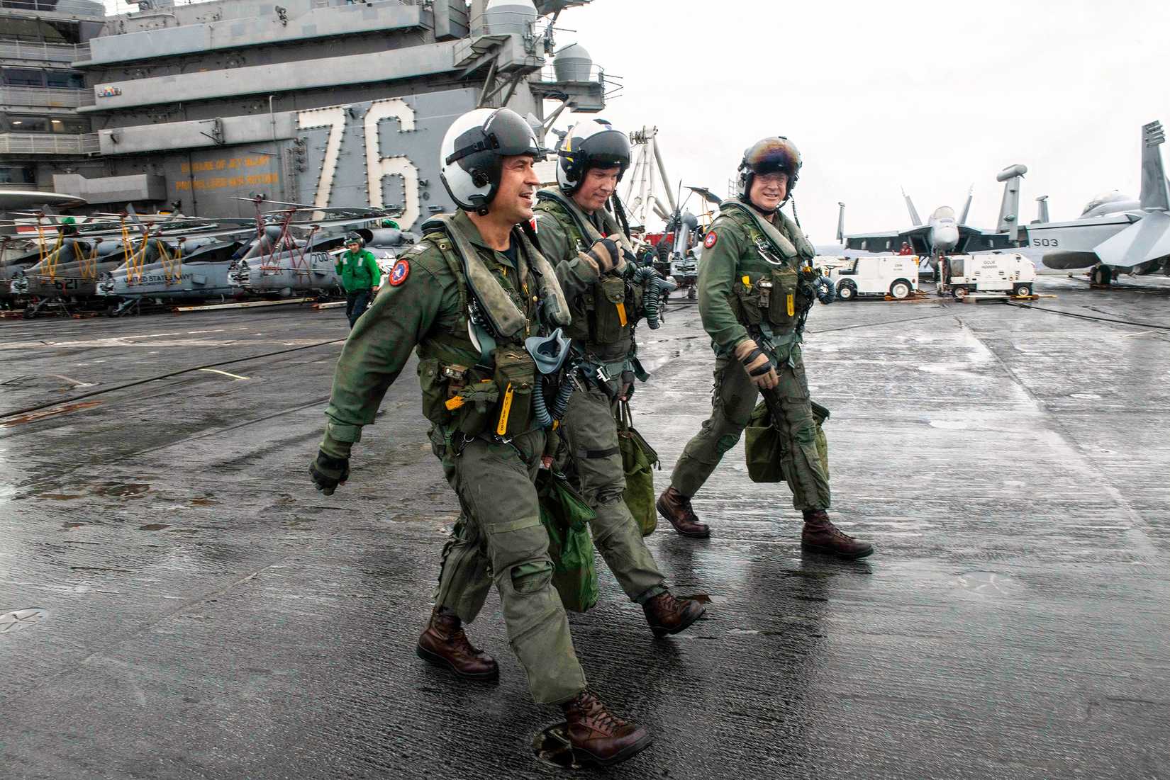 Commander of Carrier Air Wing 5 and two Captains on the flight deck aboard the Navy’s aircraft carrier USS Ronald Reagan (CVN 76)