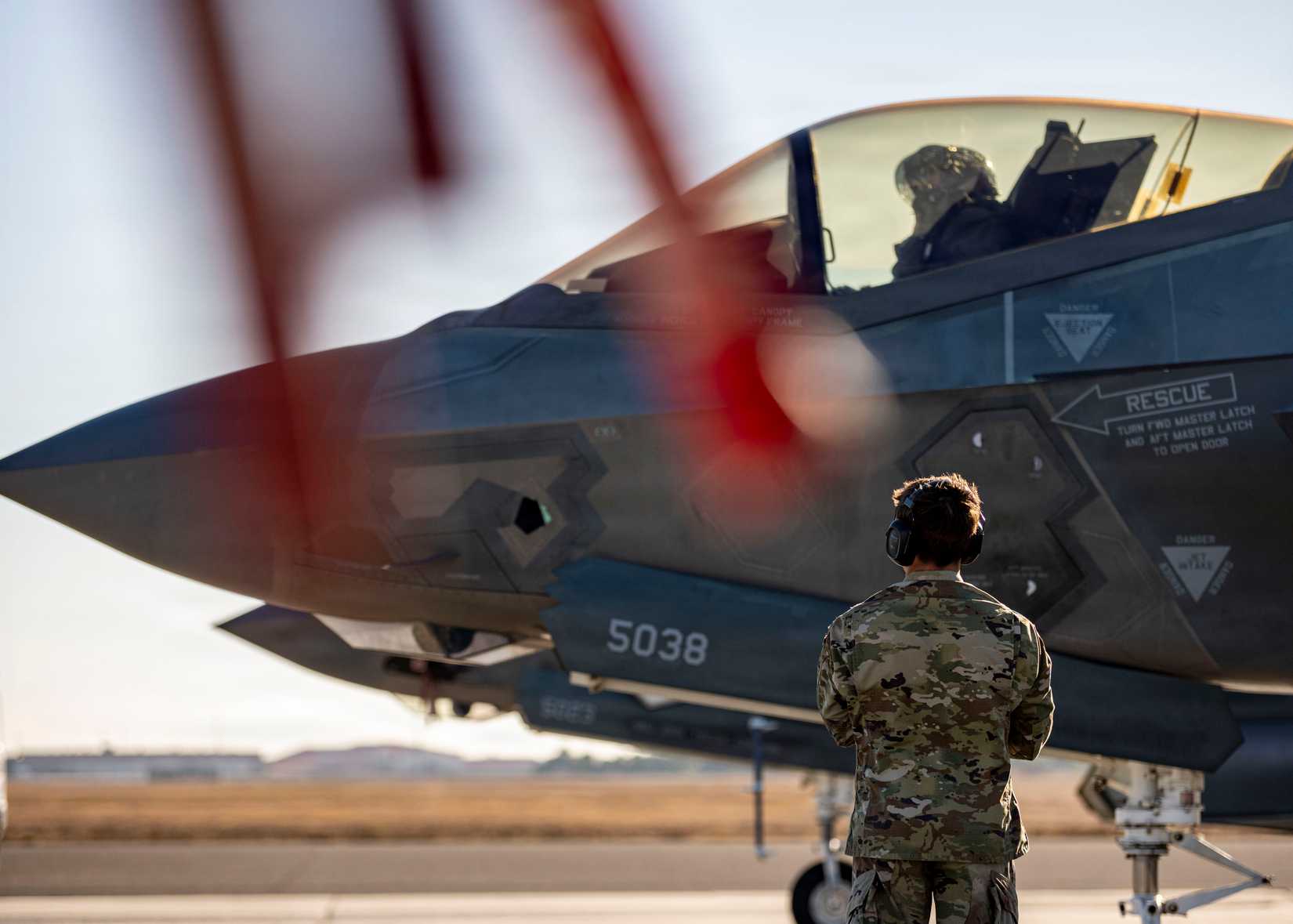 60th Aircraft Maintenance Unit crew chief, prepares to marshal F-35A Lightning II aircraft.