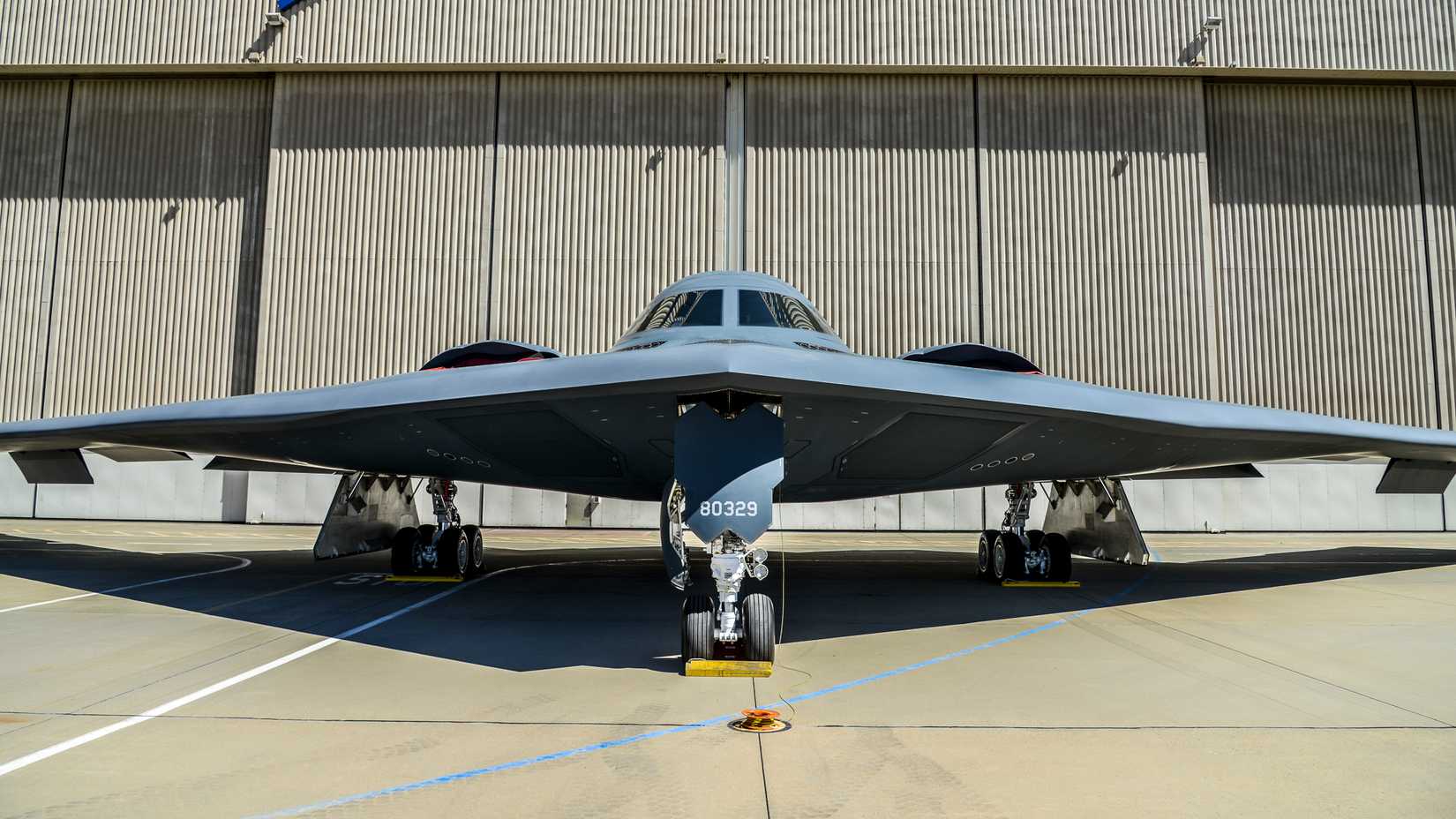 A B-2 Spirit is displayed in front of a hangar at Plant 42 in Palmdale, California.