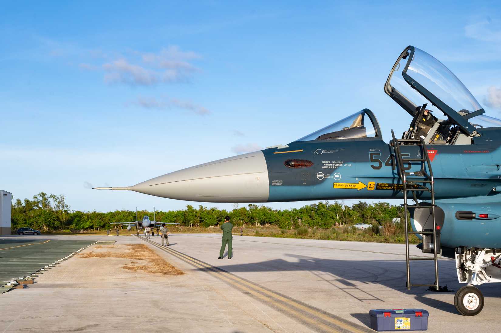 A Japan Air Self Defense Force F-15J Eagle taxis behind Mitsubishi F-2As.