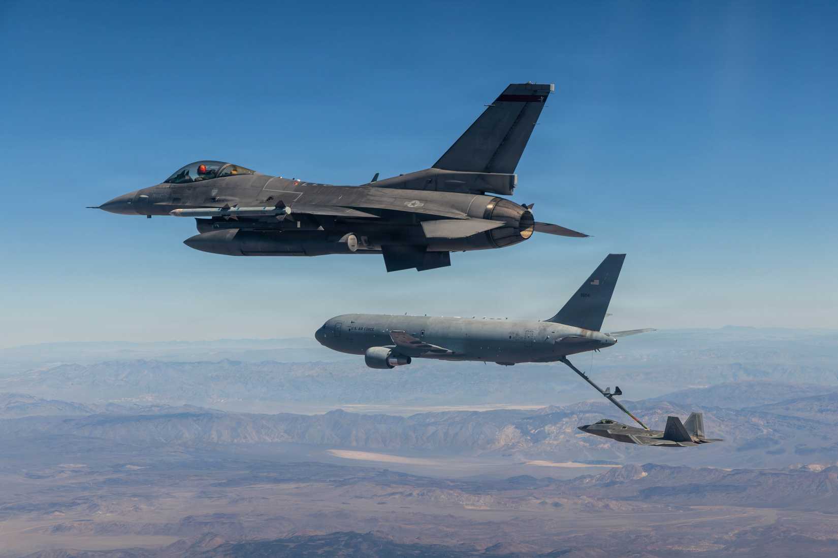 A KC-46 Pegasus assigned to the 418th Flight Test Squadron, Global Reach Combined Test Force flies with an F-22 and F-16.