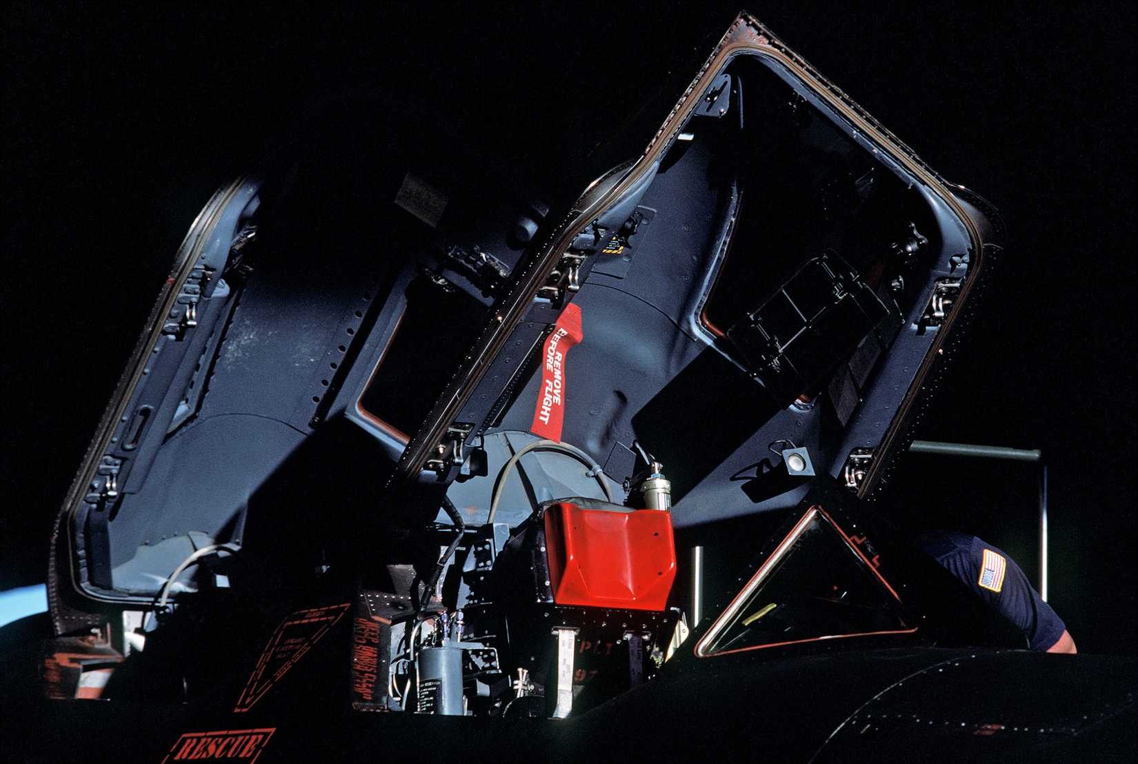 A seat and raised canopies of an SR-71B Blackbird strategic reconnaissance training aircraft.