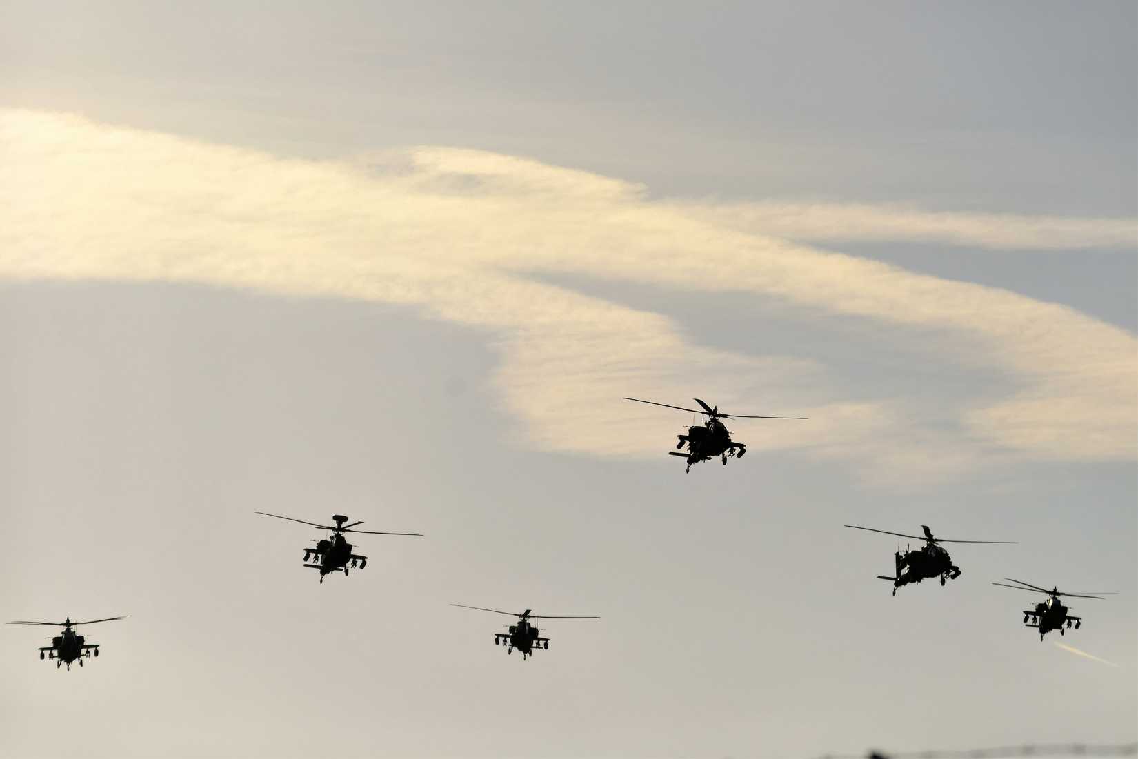 A group of AH-64 Apache's flying in formation