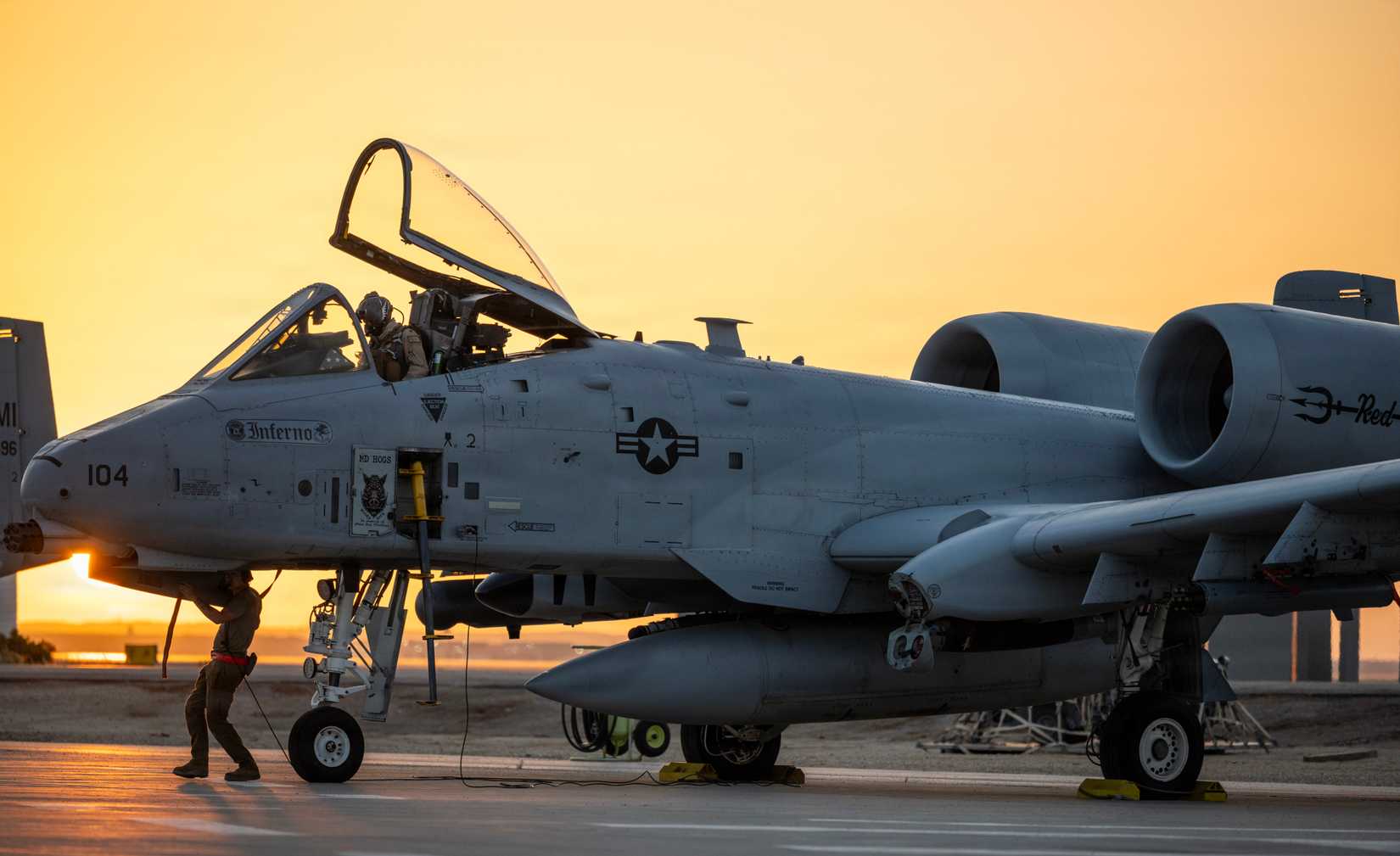 Air Force crew chief performs a pre-flight inspection on an A-10 Thunderbolt II aircraft.