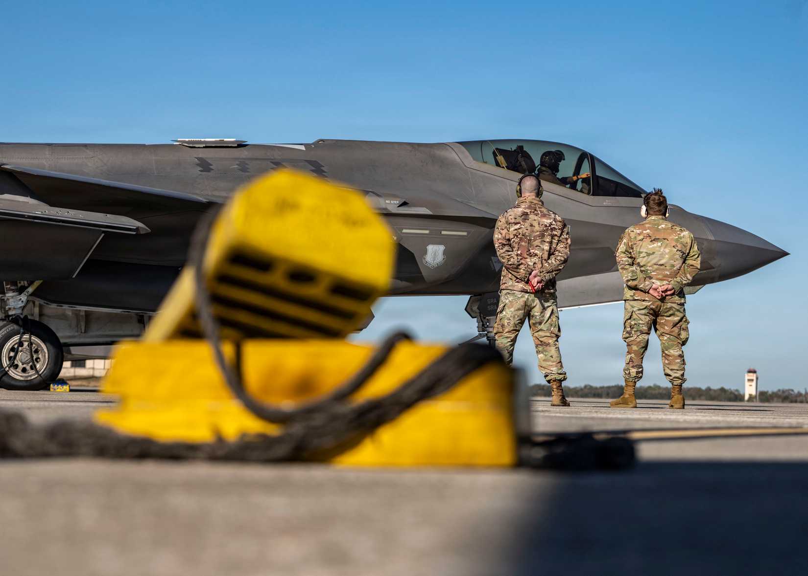 Air Force crew chiefs assigned to the 60th Aircraft Maintenance Unit prepare to marshal F-35A Lightning II aircraft on the flightline at MacDill Air Force Base, Florida, Feb. 11, 2026.