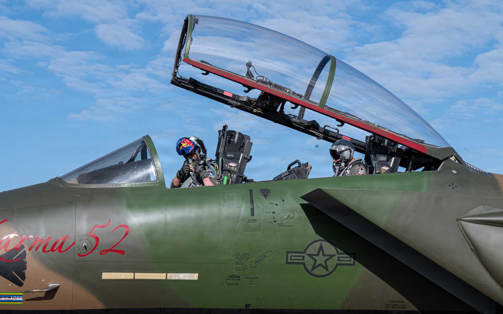 Air Force Lt. Col. Michael Overstreet, 492nd Fighter Squadron pilot and Lt. Col. Tyler Stark, 494th Fighter Squadron pilot, prepare a fly the newly-painted F-15E Strike Eagle.
