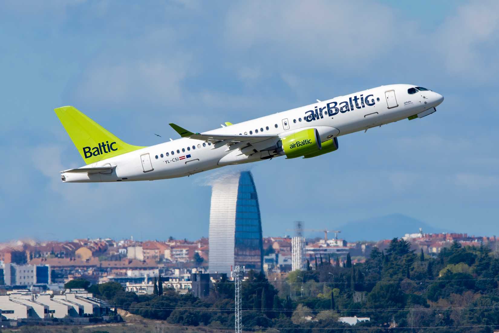 Airbus A220 airliner of Air Baltic taking off at Madrid Barajas airport with registration YL-CSI.