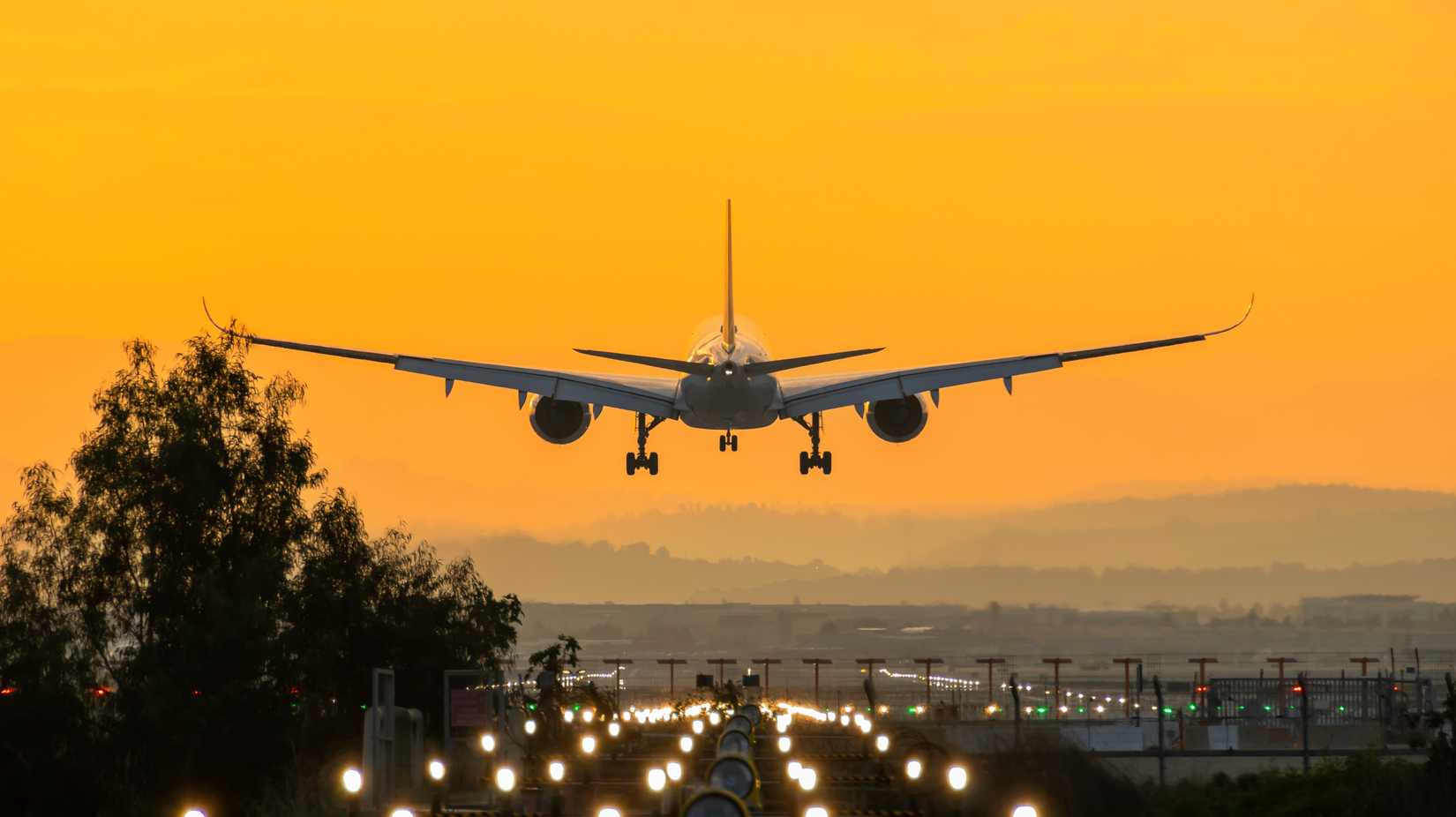 Airbus A350 landing at Ben Gurion Airport during sunrise.