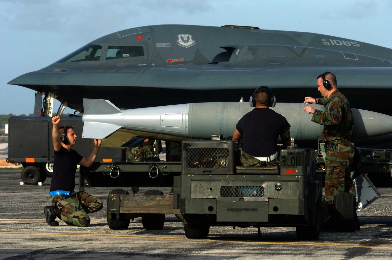 Airmen prepare to load a BDU-56 bomb on a B-2 Spirit bomber.