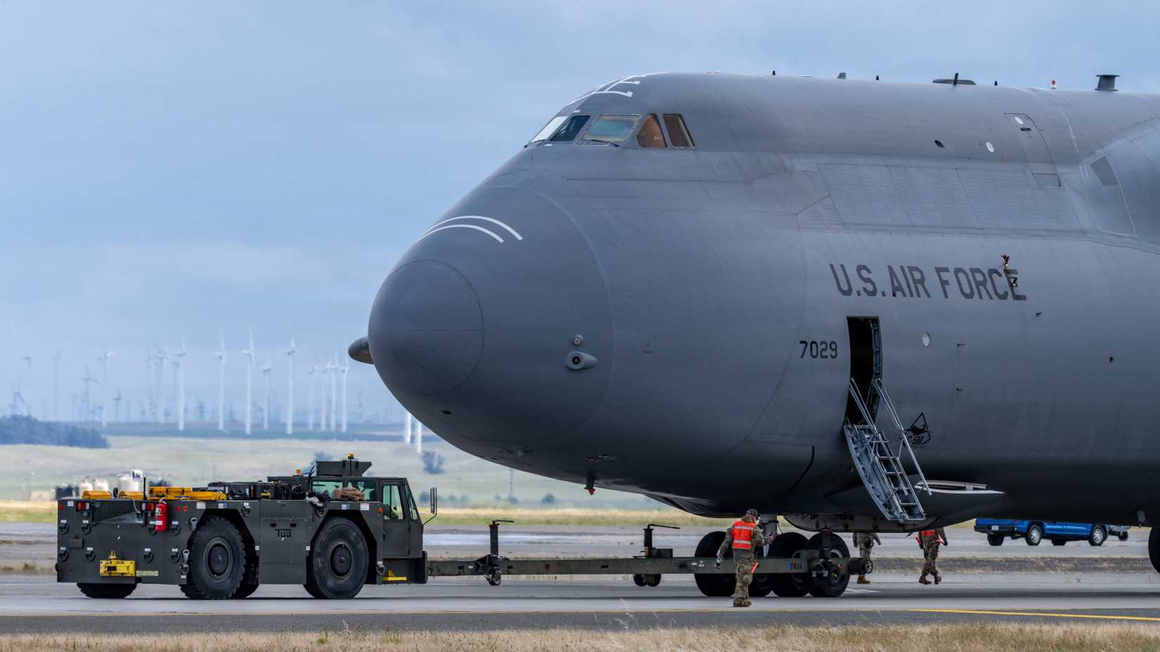 Airmen tow a C-5M Super Galaxy on the flight line at Travis Air Force Base, California, April 21, 2026.