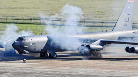 A B-52 on the apron with exhaust surrounding its engines.