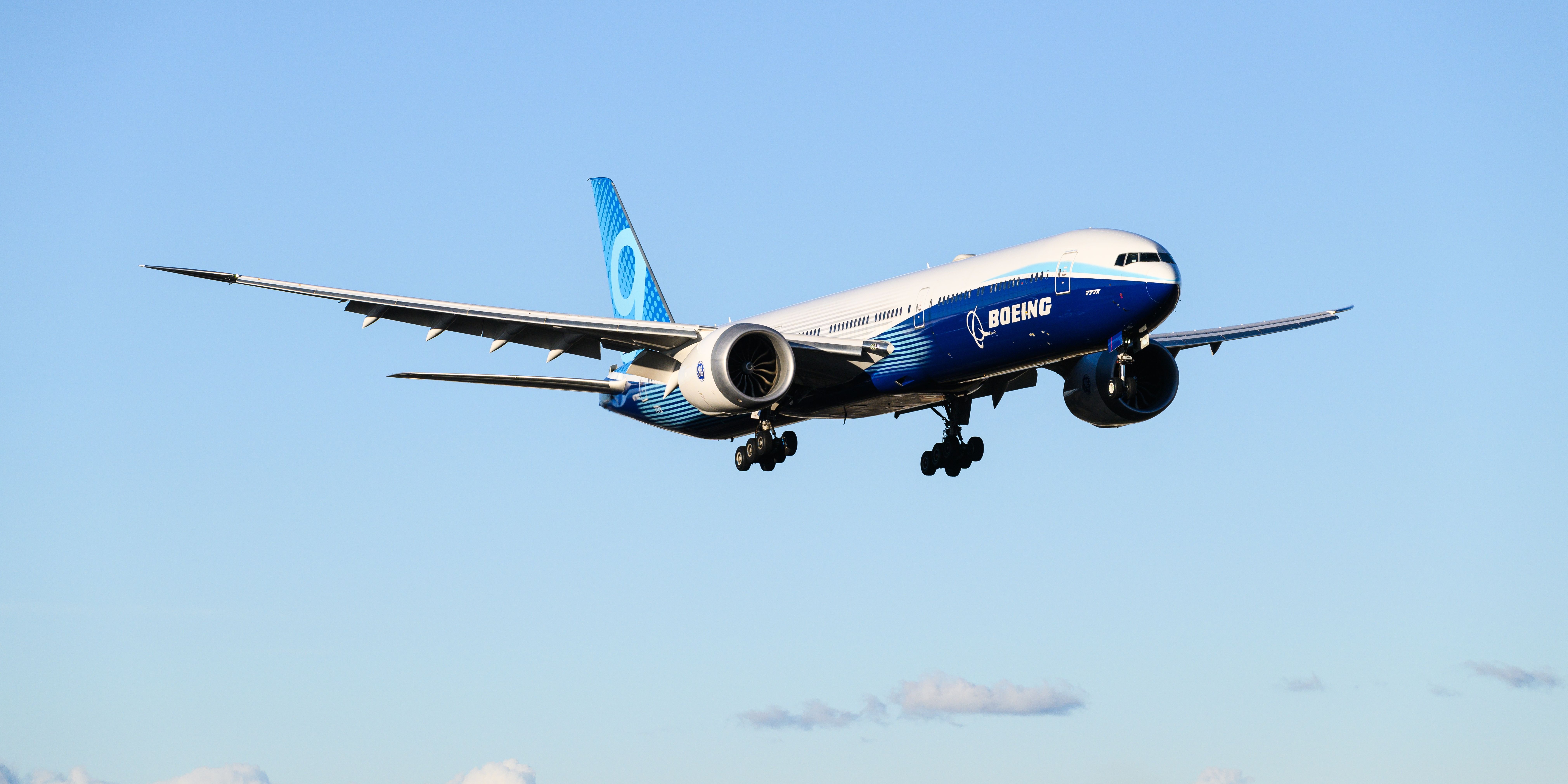 Boeing 777-9 prototype landing with landing gear down.