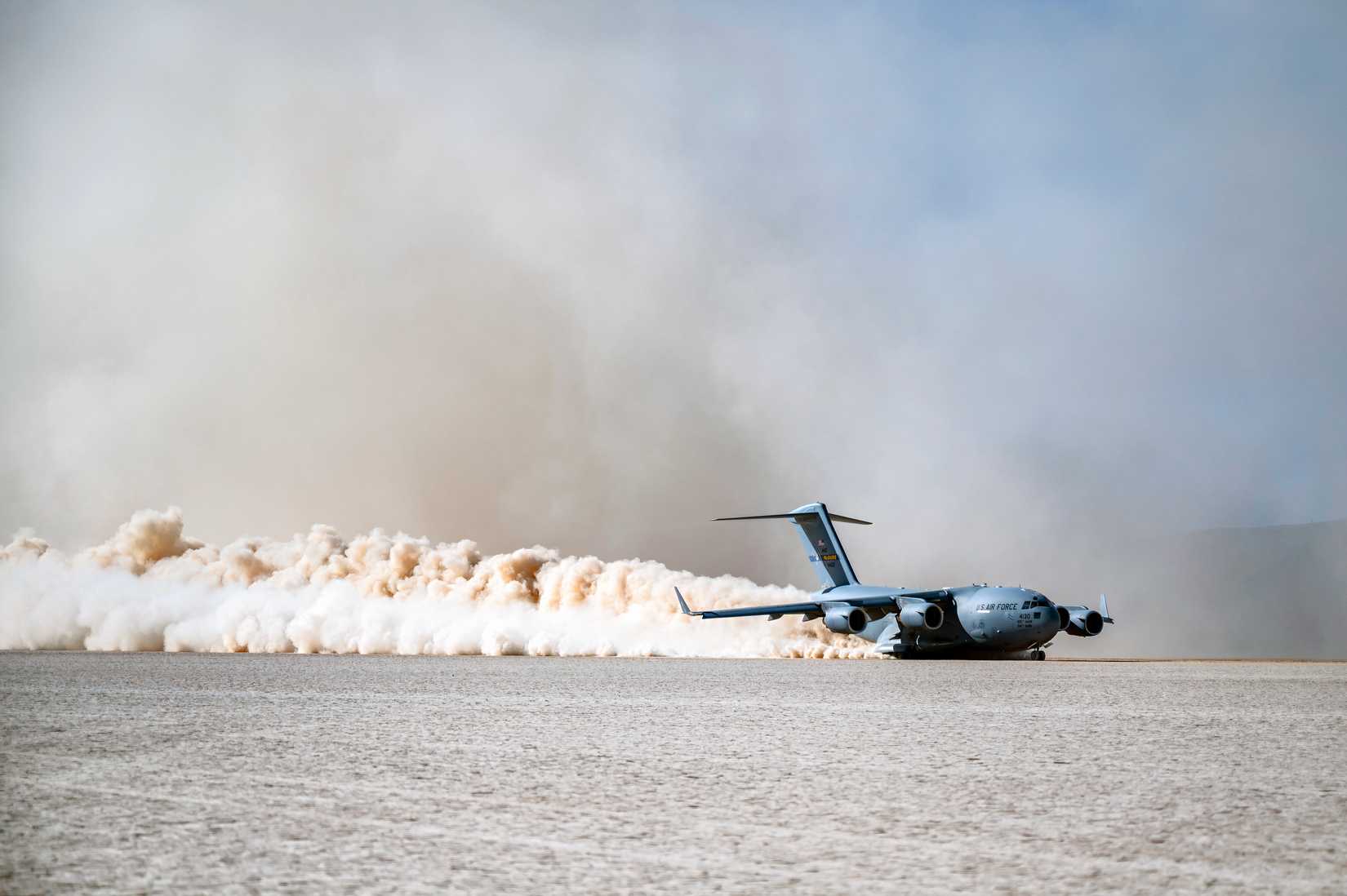 A C-17 landing on a rough landing strip.