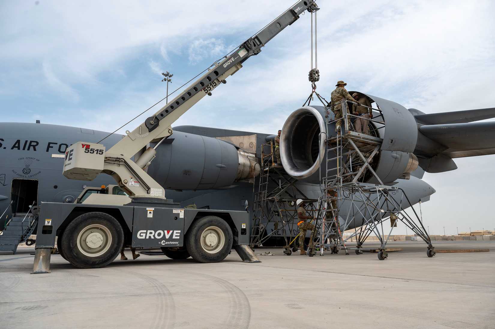A crew working to repair the engine of a C-17.