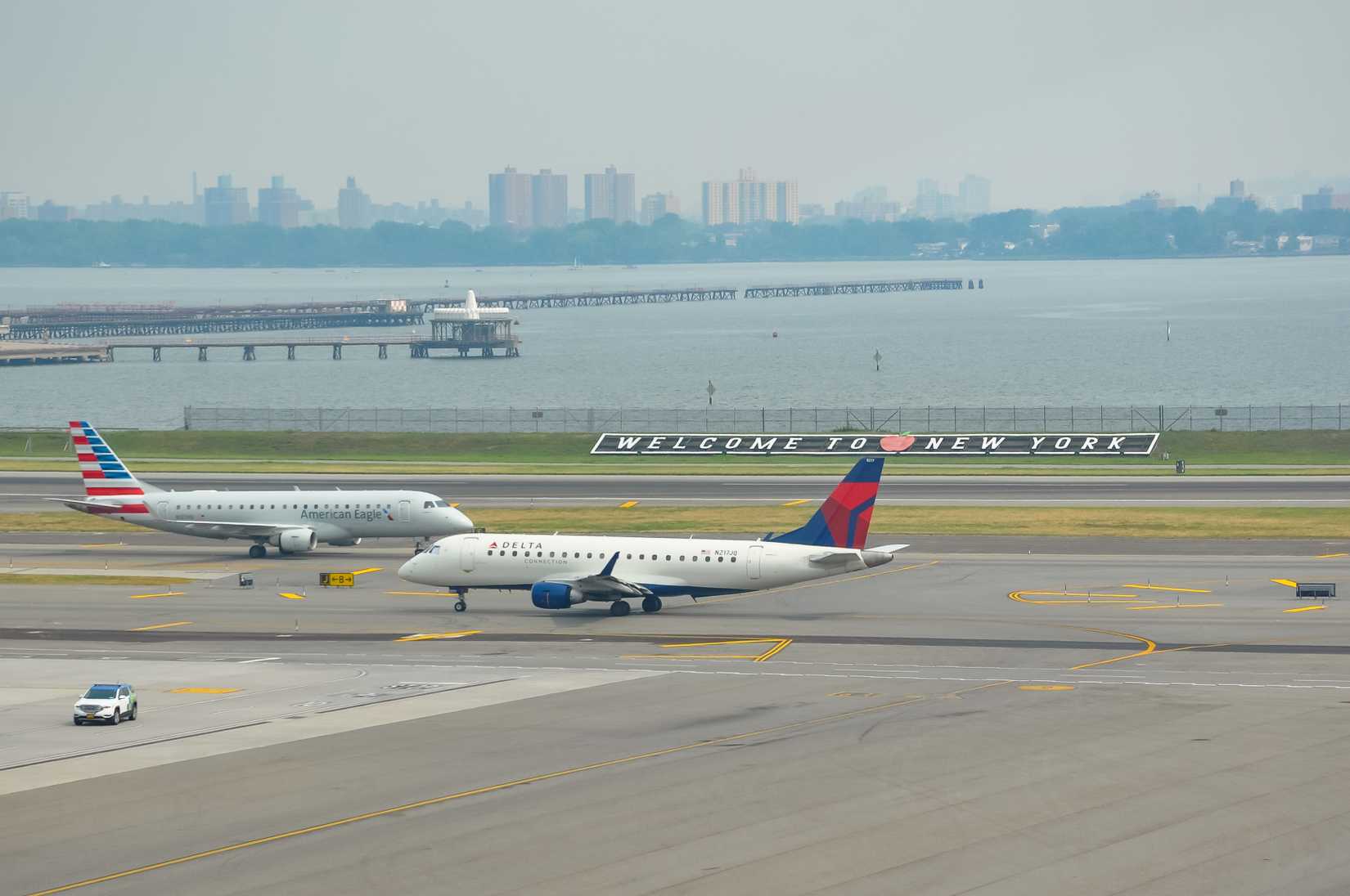 Delta Airlines and American Eagle planes seen at the runway of LaGuardia International Airport.