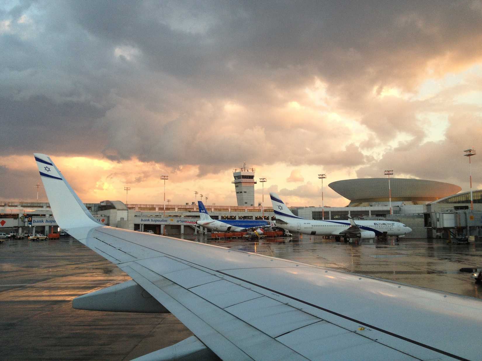 El Al planes parked at Ben Gurion Airport at sunset after rain.