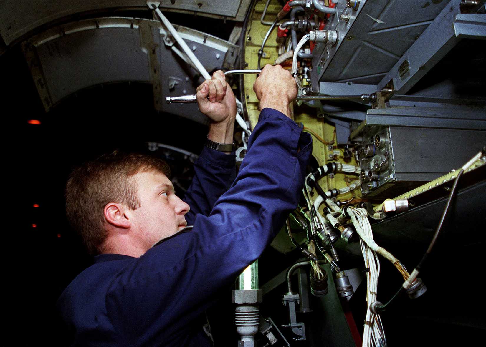 Aviation Electronics Technician 3rd Class Chrs Maze installs a radar transmitter into an F-14 Tomcat aboard the aircraft carrier USS NIMITZ (CVN 68). Nimitz is operating in the Persian Gulf in support of Operation Southern Watch.