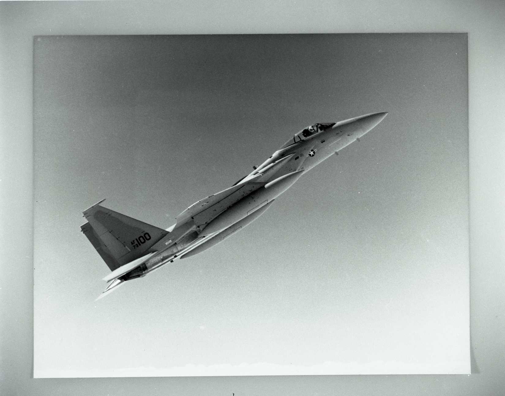 Black and White photo of an F-15 in a vertical climb