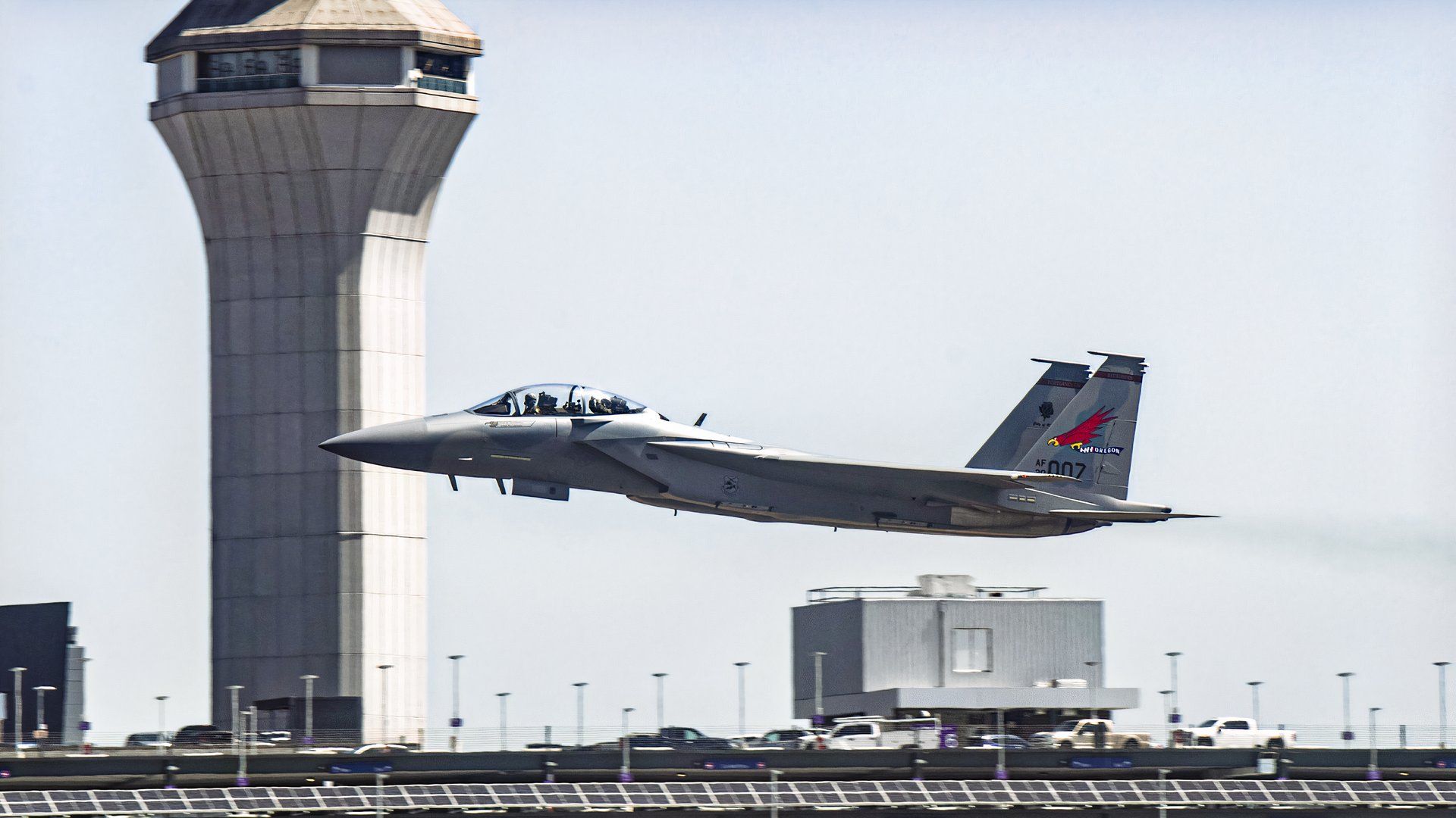 F-15 flying low near an airport or airbase.
